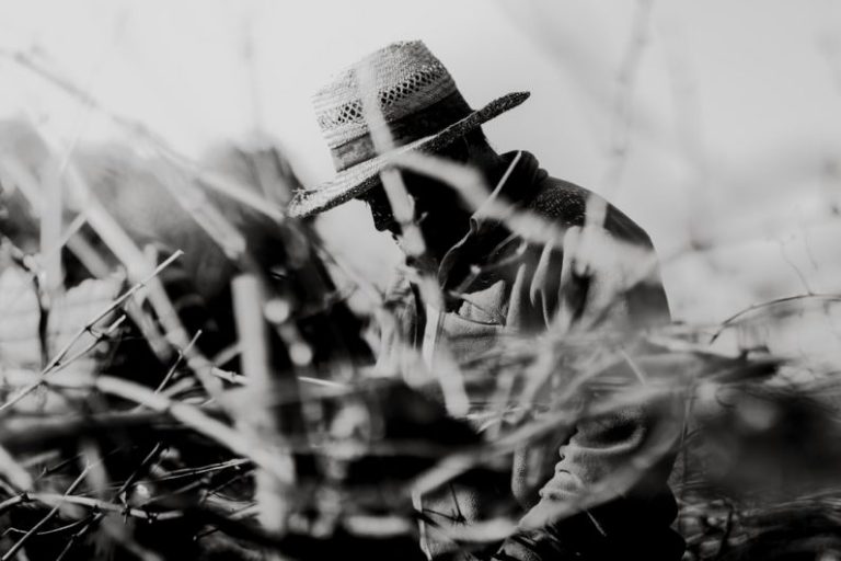 Hidden Islands - grayscale photography of man wearing hat