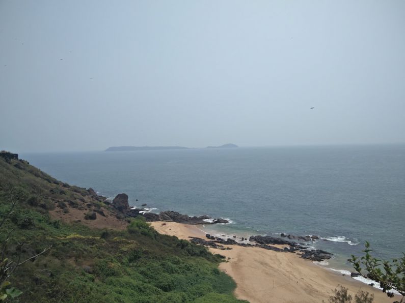 Hidden Beaches - a view of the ocean from the top of a hill