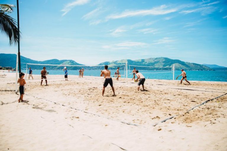 Beach Sports - men playing volleyball on sand
