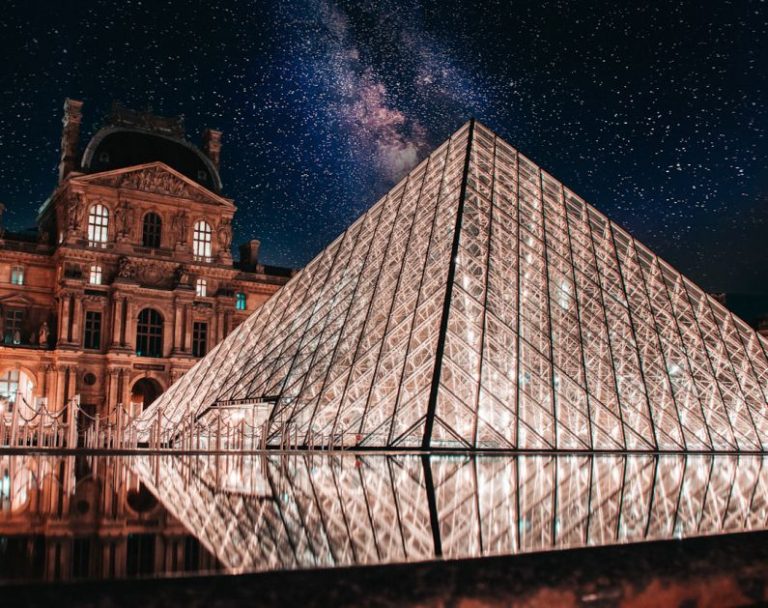Landmarks - a large glass pyramid sitting in front of a building
