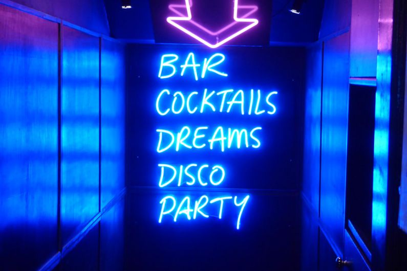 Nightlife - neon sign reading bar cocktails dreams disco party