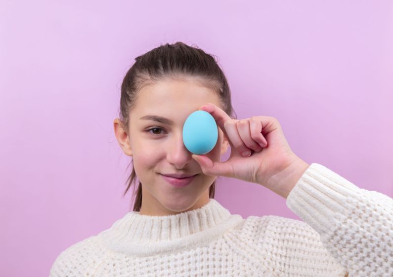 Culinary Events - woman in white sweater holding blue egg