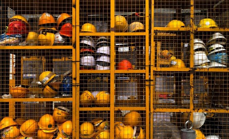 Safety - a rack filled with lots of yellow hard hats